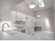 Modern kitchen with white appliances, sleek countertops, and a vaulted ceiling with skylight at 39650 Us Highway 19 N # 615, Tarpon Springs, FL 34689