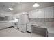 Well-equipped kitchen featuring white cabinetry, appliances, and an adjacent eat-in area at 39650 Us Highway 19 N # 615, Tarpon Springs, FL 34689