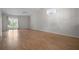 Bright living room with wood floors, a chandelier and ceiling fan, and sliding doors to the patio at 39650 Us Highway 19 N # 615, Tarpon Springs, FL 34689