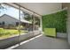Screened in patio featuring a decorative plant wall with a vintage chest at 39650 Us Highway 19 N # 615, Tarpon Springs, FL 34689