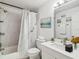 Modern bathroom features a shower-tub combo with marble-patterned walls, a sleek vanity, and contemporary fixtures at 4229 Redcliff Pl, New Port Richey, FL 34652