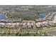 An aerial shot displays an organized community with green spaces, pools, and serene lakes at 4782 Night Star Trl, Odessa, FL 33556
