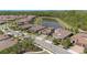 An aerial view displays the neighborhood with manicured lawns and a tranquil lake at 4782 Night Star Trl, Odessa, FL 33556