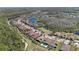 An aerial panorama shows beautiful community homes nestled around a scenic lake at 4782 Night Star Trl, Odessa, FL 33556