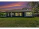 A serene backyard with a covered patio and well-maintained lawn, offering a perfect outdoor retreat at 4782 Night Star Trl, Odessa, FL 33556
