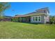 Spacious backyard with a screened-in lanai and lush green lawn at 4782 Night Star Trl, Odessa, FL 33556