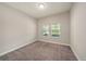 Bedroom with plush carpeting and natural light streaming through the windows at 4782 Night Star Trl, Odessa, FL 33556
