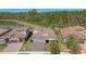 A stunning aerial view of the home features a landscaped yard and serene pond backdrop at 4782 Night Star Trl, Odessa, FL 33556