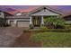 A gorgeous exterior view reveals a brick driveway, manicured lawn, and inviting entrance at 4782 Night Star Trl, Odessa, FL 33556