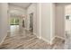 Hallway features stylish wood-look tile flooring leading to a dining area and bathroom at 4782 Night Star Trl, Odessa, FL 33556