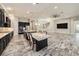 Open-concept kitchen featuring a large island with seating, stainless steel appliances, and adjacent living space at 4782 Night Star Trl, Odessa, FL 33556