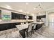 Modern kitchen featuring stainless appliances, pendant lighting, tile backsplash, island with marble counter and seating at 4782 Night Star Trl, Odessa, FL 33556