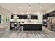Bright kitchen boasts stainless steel appliances, dark cabinets, marble countertops, and large island at 4782 Night Star Trl, Odessa, FL 33556