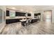 Spacious kitchen features dark cabinetry, marble countertops, stainless appliances, and a large center island with chairs at 4782 Night Star Trl, Odessa, FL 33556