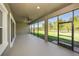 Screened lanai with ceiling fan overlooking the backyard and lake at 4782 Night Star Trl, Odessa, FL 33556