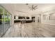 Spacious open living area featuring tile floors, access to the modern kitchen, and outdoor views at 4782 Night Star Trl, Odessa, FL 33556