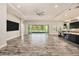 Expansive open-plan living area with access to the lanai and a modern kitchen at 4782 Night Star Trl, Odessa, FL 33556