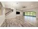 Spacious living room with staircase, tile floors, a ceiling fan, and sliding doors to the outdoors at 4782 Night Star Trl, Odessa, FL 33556