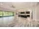 Large, open living space featuring tile flooring, a ceiling fan, and access to the kitchen and backyard at 4782 Night Star Trl, Odessa, FL 33556