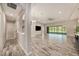 Open-concept living room with tile flooring, high ceilings, fan, and sliding glass doors at 4782 Night Star Trl, Odessa, FL 33556