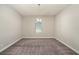 Spacious carpeted room with a centered chandelier and a window with blinds at 4782 Night Star Trl, Odessa, FL 33556