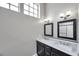 Bathroom featuring dual sink vanity with marble countertop and black framed mirrors at 5159 Sterling Manor Dr, Tampa, FL 33647