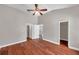 Bright bedroom with wood-look floors, ceiling fan, and access to the bathroom and closet at 5159 Sterling Manor Dr, Tampa, FL 33647