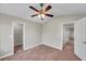 Bedroom featuring plush carpet, two closets, and an overhead ceiling fan with lights at 5159 Sterling Manor Dr, Tampa, FL 33647