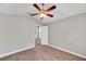 Bedroom featuring plush carpet, large windows with blinds, and an overhead ceiling fan at 5159 Sterling Manor Dr, Tampa, FL 33647