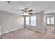 The bedroom has neutral walls, carpeting, a ceiling fan, and windows, creating a bright and inviting space at 5159 Sterling Manor Dr, Tampa, FL 33647
