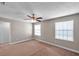 Bright bedroom with large windows, neutral carpet, and a ceiling fan with overhead lighting at 5159 Sterling Manor Dr, Tampa, FL 33647