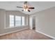 Bedroom featuring plush carpet, large windows with blinds, and an overhead ceiling fan at 5159 Sterling Manor Dr, Tampa, FL 33647