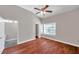 Bright and spacious bedroom with a ceiling fan, wood-look floors, and a view of the bathroom at 5159 Sterling Manor Dr, Tampa, FL 33647