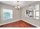 Dining room with view into the kitchen, a chandelier, and natural light from the window at 5159 Sterling Manor Dr, Tampa, FL 33647