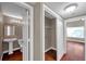 Hallway view showcasing access to a laundry closet, bathroom, and other rooms with wood-look floors at 5159 Sterling Manor Dr, Tampa, FL 33647
