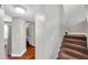 Inviting hallway featuring wood floors, neutral walls, and a staircase leading to the upper level at 5159 Sterling Manor Dr, Tampa, FL 33647
