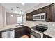 Stylish kitchen with stainless steel appliances, granite counters, and dark wood cabinetry at 5159 Sterling Manor Dr, Tampa, FL 33647