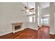Inviting living room featuring wood floors, fireplace, and high ceilings for added space and comfort at 5159 Sterling Manor Dr, Tampa, FL 33647
