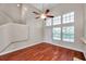 Bright living room featuring wood floors and tall windows for natural light, plus ceiling fan at 5159 Sterling Manor Dr, Tampa, FL 33647