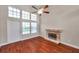 Bright living room featuring a fireplace, wood floors, and tall windows for natural light at 5159 Sterling Manor Dr, Tampa, FL 33647