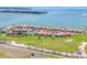 Aerial view showing community with beach access, tennis courts, and green spaces at 5625 Escondida S Blvd, St Petersburg, FL 33715