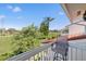 Relaxing balcony view overlooking lush green space with mature trees and blue skies at 5625 Escondida S Blvd, St Petersburg, FL 33715