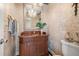 Stylish half bath with vanity, decorative mirror, elegant lighting, and unique wallpaper offers sophisticated comfort at 5625 Escondida S Blvd, St Petersburg, FL 33715
