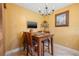 A cozy dining area is adjacent to the kitchen and provides a TV for viewing while dining at 5625 Escondida S Blvd, St Petersburg, FL 33715