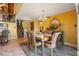 Elegant dining room with a chandelier, staircase, and stairs leading to the upper level loft at 5625 Escondida S Blvd, St Petersburg, FL 33715