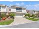 Inviting two-story townhouse with a well-kept lawn, lovely landscaping, and a private driveway leading to a garage at 5625 Escondida S Blvd, St Petersburg, FL 33715