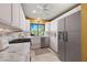 This kitchen is equipped with stainless steel appliances, marble countertops, tile backsplash, and a stainless steel refrigerator at 5625 Escondida S Blvd, St Petersburg, FL 33715