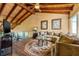Cozy living room with vaulted wood ceilings, comfortable seating, and a unique circular rug at 5625 Escondida S Blvd, St Petersburg, FL 33715