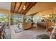 An open concept living space offers tile floors, wood ceilings, and a wall of mirrors for a bright interior at 5625 Escondida S Blvd, St Petersburg, FL 33715