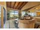 Spacious living room with wood ceiling, expansive windows, and view of the golf course at 5625 Escondida S Blvd, St Petersburg, FL 33715